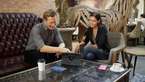 Two people collaborating on a tablet