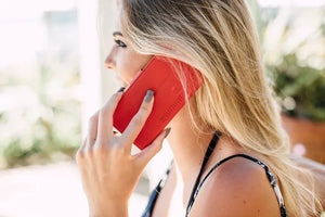 Woman on phone with red case