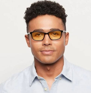 Man wearing blue light blocking glasses