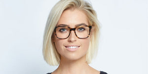 Woman with blonde hair and glasses