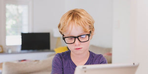 Boy with glasses using tablet BB8567