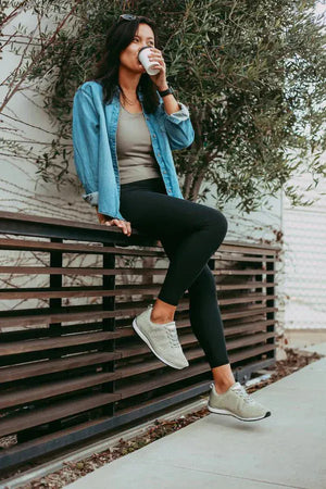 Woman in Platinum Knit Lace-Up shoes, drinking coffee