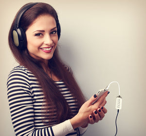 Woman with headphones listening to music on phone, CC2936