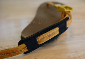 Sandal strap detail with yellow and black accents