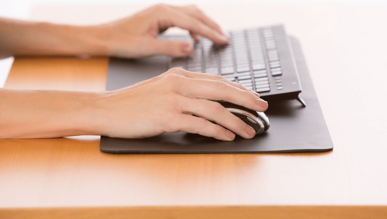 User typing on keyboard and using mouse, EA1840