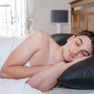 Man sleeping peacefully on pillow in bed
