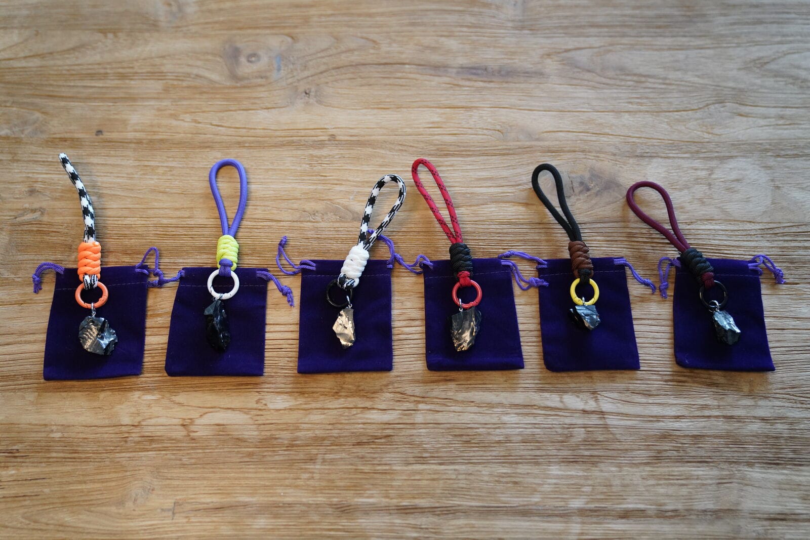 Shungite keyrings with colorful cords and purple pouches