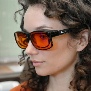 Woman wearing FitOver blue light blocking glasses
