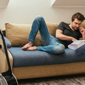 Man relaxing on couch reading book, GO15039_1