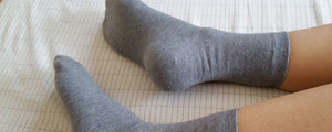 Grey socks on bed - GOSK15815