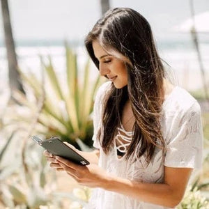 GS10 Black Case - Woman looking at phone near beach