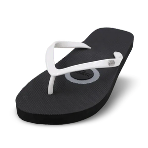 Black and white grounding flip-flops on beach