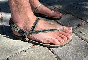 Feet wearing minimalist sandals