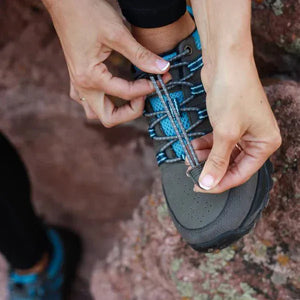 Tying grey & blue speed lace trail shoe