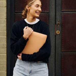 Woman smiling, holding laptop, WP10392