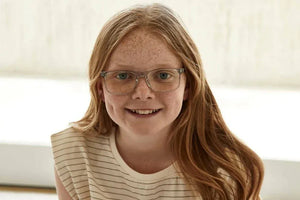 Addison wearing crystal glasses, smiling