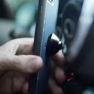 Adhesive phone case style in use, with car dashboard visible.