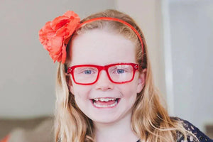 Bailey wearing red crystal glasses and flower headband
