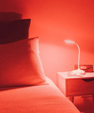 Red light therapy lamp on nightstand