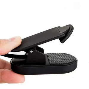 Amber no-blue book light clipped to a hand.