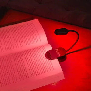 Book illuminated with red light from a Block Blue Light book light.
