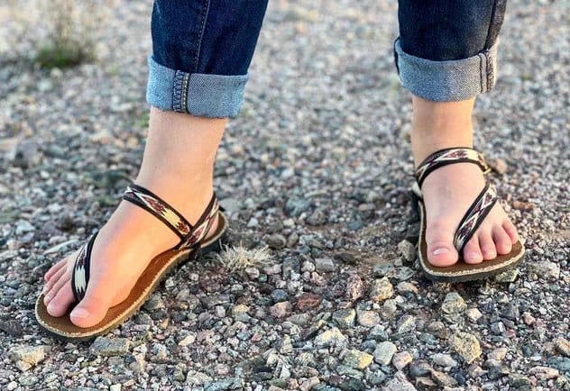 Minimalist tribal sandals on child's feet.