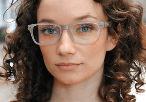 Woman wearing DefenderShield blue light glasses