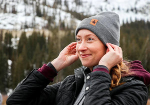 Woman wearing DefenderShield EMF protection winter beanie