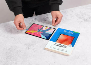 Applying blue light filter screen protector to iPad