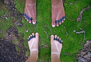 Feet with toe spacers on moss