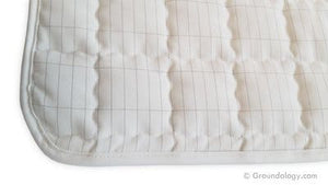Quilted white pad with grid pattern