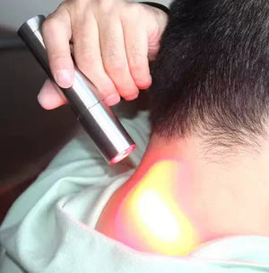 Red light therapy torch treating neck pain