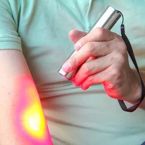 Red light therapy torch on arm