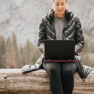 Woman using laptop outdoors, lifestyle
