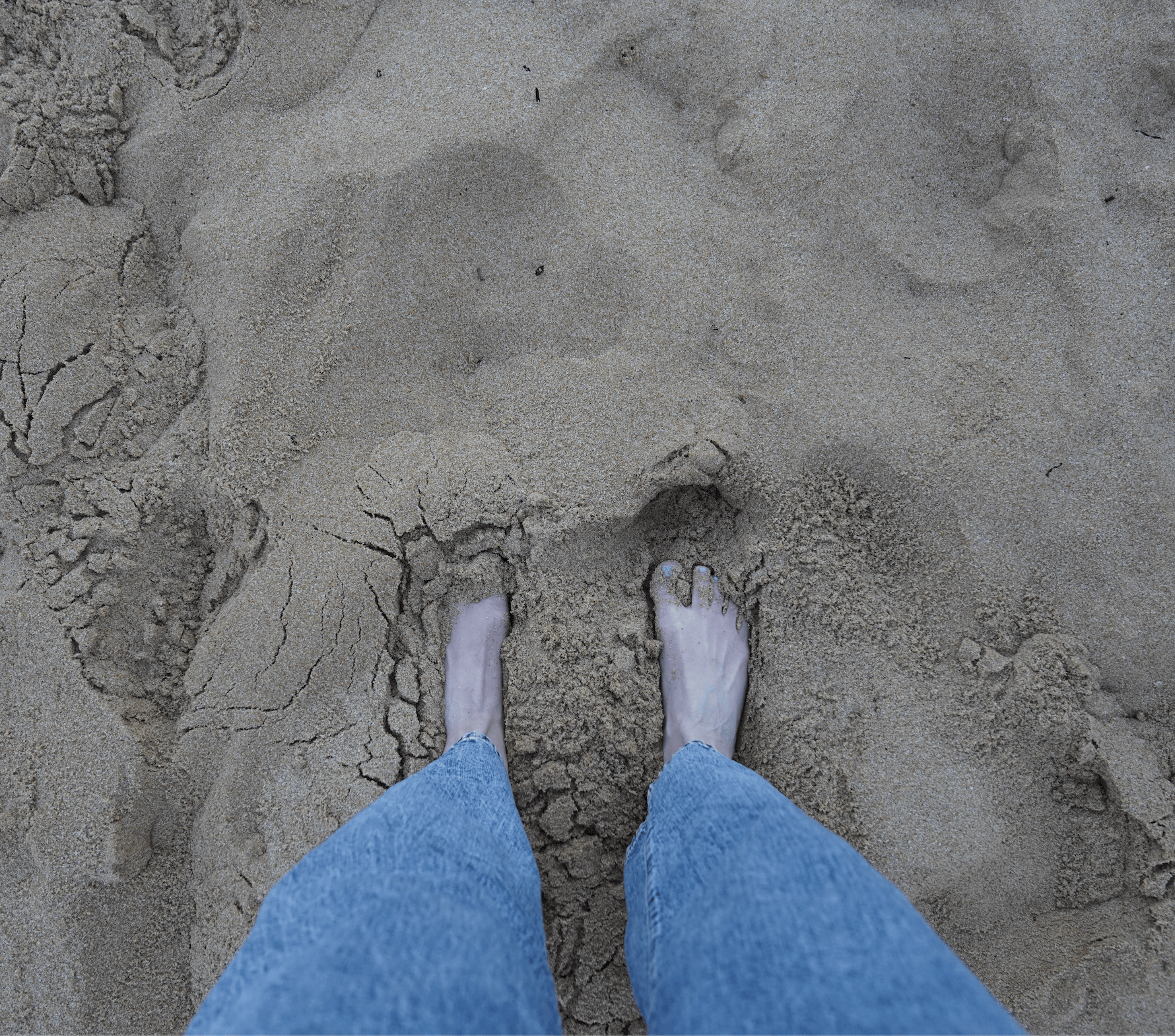 Screenshot of feet in sand, September 2025
