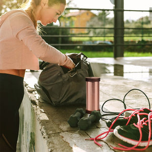 WG-QiShield supplement & woman at gym with gym bag and equipment.
